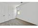 Clean, neutral bedroom with grey carpet, white walls, and a window at 31345 N 130Th Ave, Peoria, AZ 85383