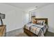Well-lit bedroom with a wooden bed frame, white walls and neutral carpet at 31345 N 130Th Ave, Peoria, AZ 85383