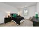 Well-lit bedroom with a black metal bed frame, dark wood nightstands, and neutral carpet at 31345 N 130Th Ave, Peoria, AZ 85383