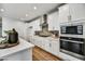 Modern kitchen featuring stainless steel appliances, white cabinets, and stylish backsplash at 31345 N 130Th Ave, Peoria, AZ 85383