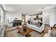 Open-concept living space with modern furniture and seamless flow into dining and kitchen areas at 31345 N 130Th Ave, Peoria, AZ 85383