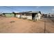 View of the back of the home and yard showing AC units and secure metal bars on windows at 3155 E Mobile Ln, Phoenix, AZ 85040