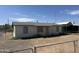 Modest single-story home with a brick facade and chain-link fence in a residential neighborhood at 3155 E Mobile Ln, Phoenix, AZ 85040