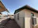 Brick home exterior featuring secure metal bars on windows and an external AC unit at 3155 E Mobile Ln, Phoenix, AZ 85040