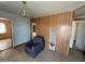 Living room with brick walls, wood paneling, a vintage chandelier, and classic interior doors at 3155 E Mobile Ln, Phoenix, AZ 85040