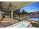 Backyard with a spa, grill area, and stone pavers with decorative turf accents for entertaining at 4300 S Marble St, Gilbert, AZ 85297