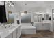Elegant bathroom with dual vanities, soaking tub, and stylish lighting at 4300 S Marble St, Gilbert, AZ 85297