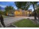 Large three car garage with desert landscaping, and exterior lighting at 4300 S Marble St, Gilbert, AZ 85297