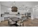 Bright kitchen featuring stainless steel appliances, granite countertops, island with seating, and dining area at 4300 S Marble St, Gilbert, AZ 85297