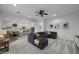Open-concept living room with grey sofa and kitchen in the background at 4300 S Marble St, Gilbert, AZ 85297