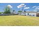 Expansive backyard with lush lawn, leading to a white brick home with a covered patio at 5328 E Yale St, Phoenix, AZ 85008