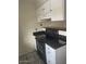 The kitchen features white cabinets, a dark countertop, and a black oven range at 653 W Guadalupe Rd # 2019, Mesa, AZ 85210