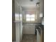 A kitchen with white cabinets, a window, and a checkered valance at 653 W Guadalupe Rd # 2019, Mesa, AZ 85210