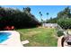 Expansive backyard with lush lawn, mature trees, and ample space for outdoor activities and recreation at 7537 W Bluefield Ave, Glendale, AZ 85308