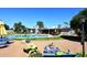 Inviting backyard features a sparkling pool, lush greenery, and outdoor seating for relaxation and entertaining at 7537 W Bluefield Ave, Glendale, AZ 85308