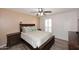 Serene bedroom showcasing a dark wood bed frame, plantation shutters, and neutral tones at 7537 W Bluefield Ave, Glendale, AZ 85308