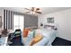 Charming bedroom featuring blue and white striped accent wall, stylish decor, and comfortable seating at 7537 W Bluefield Ave, Glendale, AZ 85308
