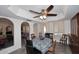 Open dining room with large windows and a decorative ceiling fan at 7537 W Bluefield Ave, Glendale, AZ 85308