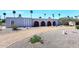 Unique home exterior featuring arched entryways, desert landscaping, and circular driveway at 7537 W Bluefield Ave, Glendale, AZ 85308