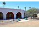 Charming home featuring a stucco exterior, arched entryways, and vibrant blue potted plants enhancing curb appeal at 7537 W Bluefield Ave, Glendale, AZ 85308