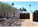 Exterior view of stucco home with RV parked behind wooden gate at 7537 W Bluefield Ave, Glendale, AZ 85308