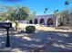 Charming home exterior with arched entryway, desert landscaping, and a well-maintained front yard at 7537 W Bluefield Ave, Glendale, AZ 85308