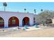 Charming arched entryway to a desert home with mature landscaping at 7537 W Bluefield Ave, Glendale, AZ 85308