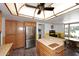 Well-lit kitchen boasting stainless steel appliances and a butcher block island, adjacent to dining area at 7537 W Bluefield Ave, Glendale, AZ 85308