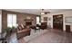 Welcoming living room with brick fireplace, leather seating, and exposed brick flooring at 7537 W Bluefield Ave, Glendale, AZ 85308