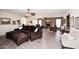 Spacious living room with exposed brick and comfortable leather furniture at 7537 W Bluefield Ave, Glendale, AZ 85308