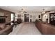 Large living room with brick fireplace, ample seating, and exposed brick flooring at 7537 W Bluefield Ave, Glendale, AZ 85308