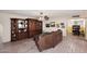 Spacious living room with brick flooring, comfortable seating, and classic built-in shelving at 7537 W Bluefield Ave, Glendale, AZ 85308