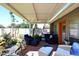 Charming covered patio with stylish furniture, potted plants, and brick flooring at 7537 W Bluefield Ave, Glendale, AZ 85308