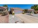 Charming single-story home featuring desert landscaping, large driveway and an attached two-car garage at 960 W Hudson Way, Gilbert, AZ 85233