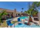 Inviting backyard pool area featuring lush landscaping and comfortable lounge furniture, ideal for relaxation and entertaining at 960 W Hudson Way, Gilbert, AZ 85233