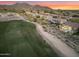 An aerial view of a golf course community showcasing homes with backyard pools, putting greens, and stunning views at 10478 E Sheena Dr, Scottsdale, AZ 85255