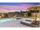 Outdoor patio area with a pool, putting green, lounge chairs, and desert mountain views at 10478 E Sheena Dr, Scottsdale, AZ 85255