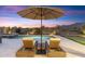 Backyard featuring lounge chairs, a patio umbrella, and a tranquil pool with a spa and putting green at 10478 E Sheena Dr, Scottsdale, AZ 85255