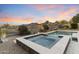 Inviting backyard with a gorgeous pool, spa, desert landscaping, and a beautiful mountain view at sunset at 10478 E Sheena Dr, Scottsdale, AZ 85255