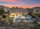 Aerial view of backyard with pool, putting green, and cozy seating area with a fire pit at 10478 E Sheena Dr, Scottsdale, AZ 85255