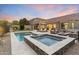 Backyard featuring a stunning pool, hot tub, fire pit, and outdoor seating perfect for entertaining guests at 10478 E Sheena Dr, Scottsdale, AZ 85255