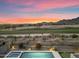 Amazing backyard view featuring a pool, spa, and putting green with a picturesque view of the golf course and mountains at 10478 E Sheena Dr, Scottsdale, AZ 85255
