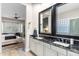 Bathroom with dual sinks and black marble countertops, adjacent to main bedroom at 10478 E Sheena Dr, Scottsdale, AZ 85255