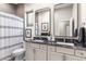 Bathroom features a granite countertop, double sinks, and modern mirrors at 10478 E Sheena Dr, Scottsdale, AZ 85255