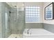 Bathroom features a soaking tub and glass shower with mosaic tile at 10478 E Sheena Dr, Scottsdale, AZ 85255