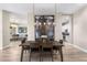Dining area featuring modern light fixture, art, and wood-look flooring at 10478 E Sheena Dr, Scottsdale, AZ 85255