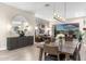 Open-concept dining room with modern lighting, stylish furniture, and seamless access to outdoor living at 10478 E Sheena Dr, Scottsdale, AZ 85255