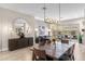 Elegant dining room with views of the patio, modern lighting, and stylish dining set at 10478 E Sheena Dr, Scottsdale, AZ 85255