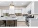 Bright kitchen featuring white cabinetry, a large island, and updated appliances at 10478 E Sheena Dr, Scottsdale, AZ 85255