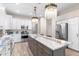 Open kitchen with a large island, stainless steel appliances, and designer lighting at 10478 E Sheena Dr, Scottsdale, AZ 85255